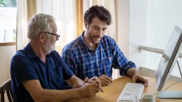 Geeks On Command technician providing in-home computer help to senior customer. Expert offering personalized tech support and computer tutorials for all ages.